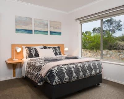 Amani bedroom where luxury and comfort intertwine to create a haven of tranquility and relaxation. As you enter, you're greeted by a sense of serenity, with soft lighting casting a warm, inviting glow over the space.